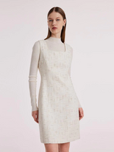 a lady in a-line sleeveless white tweed mini dress